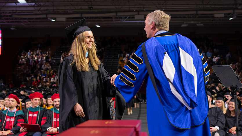 President Weinman and graduate student at Friday's Commencement. Photo by Carlo de Jesus/Marist College.